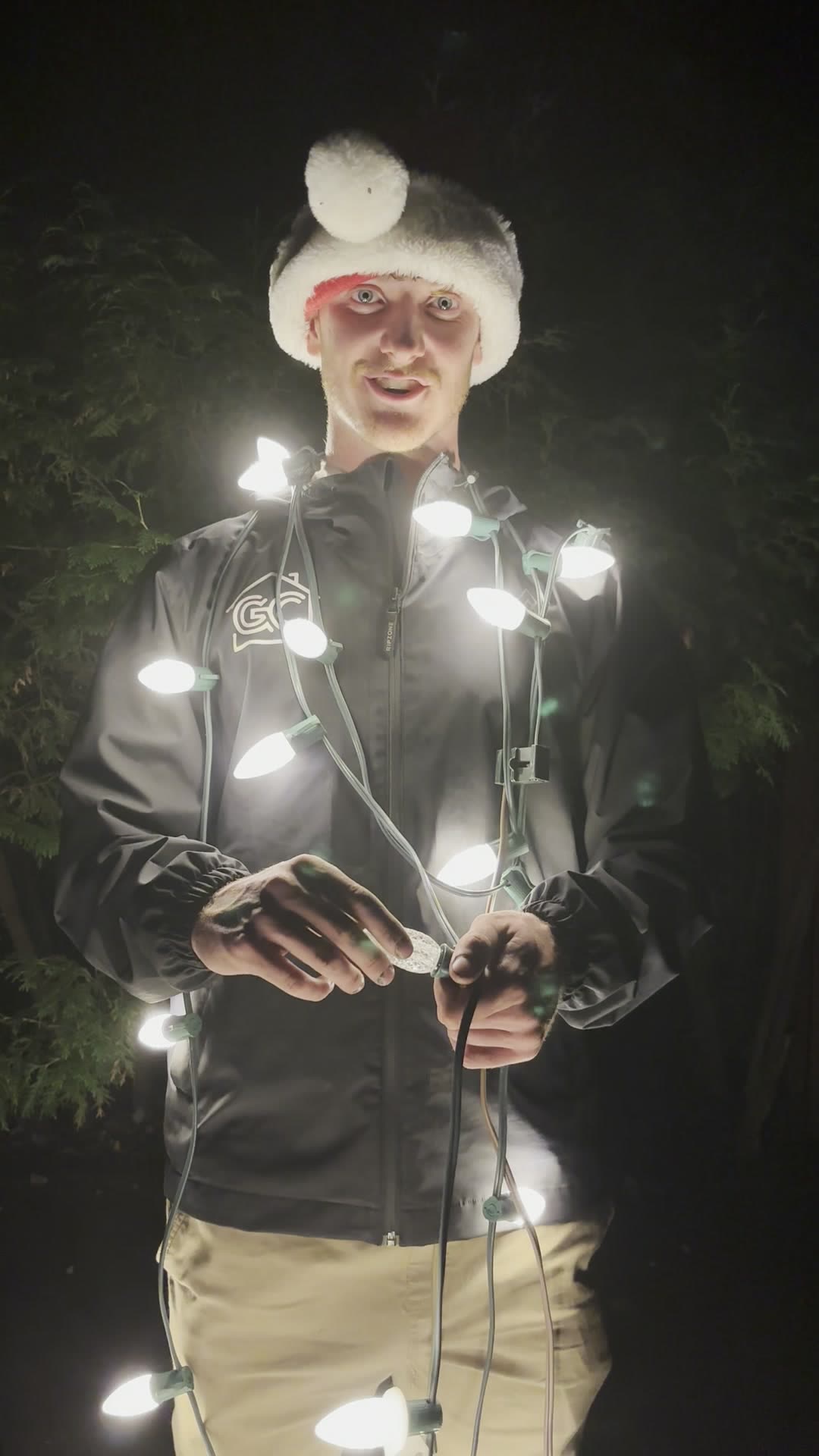GNC installer holding a string of lit C9 bulbs