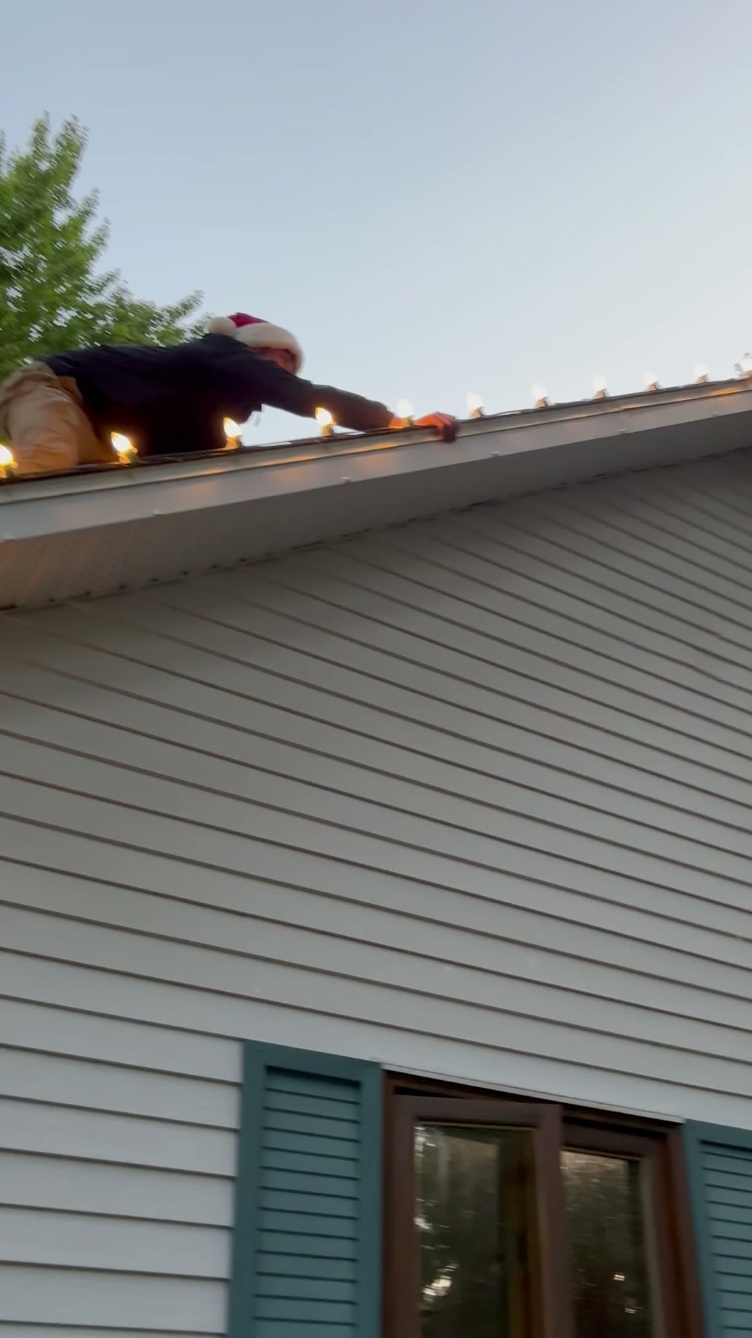 Installer on a roofline in daylight