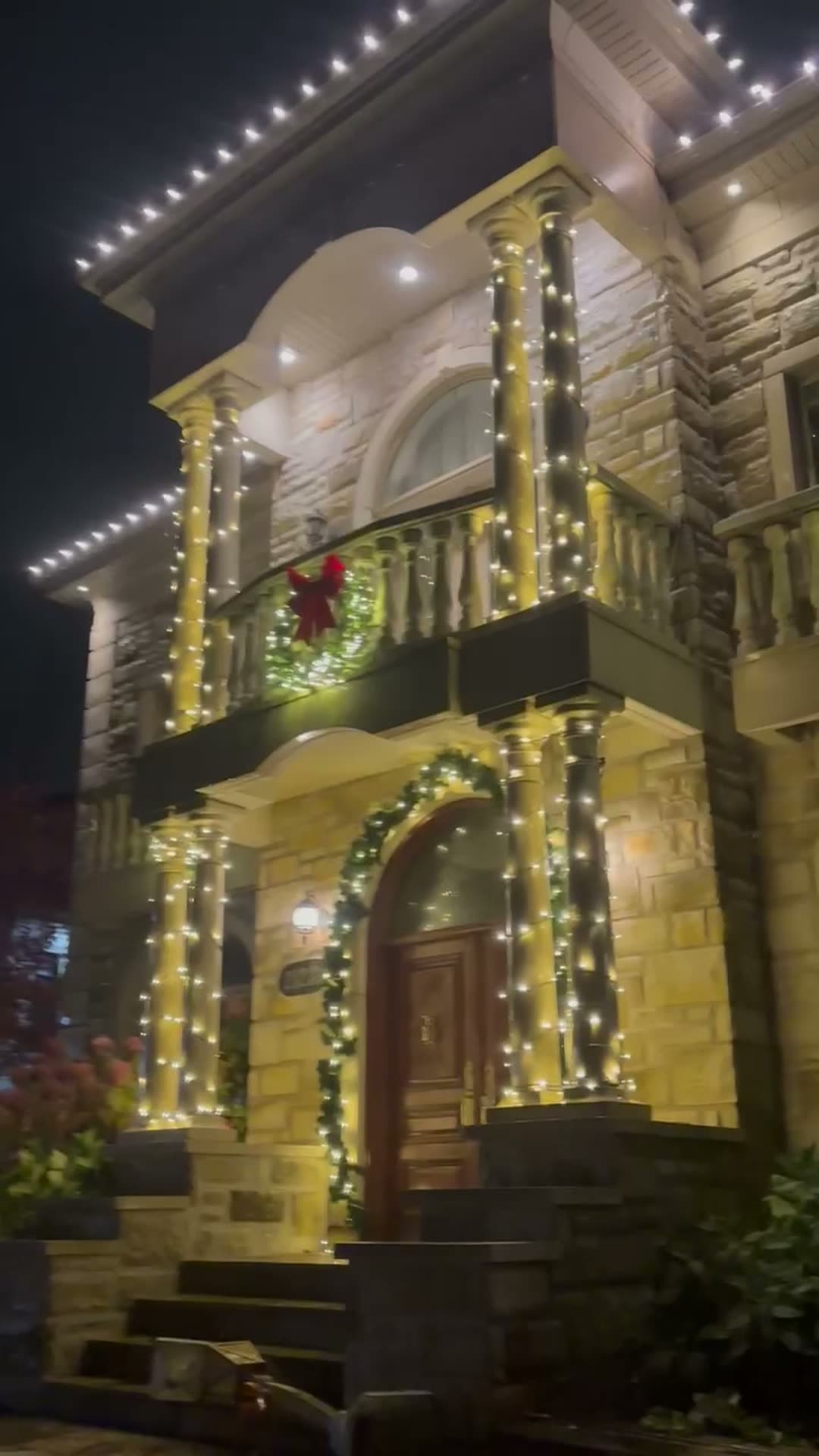 Entrance lit with garland and wreaths