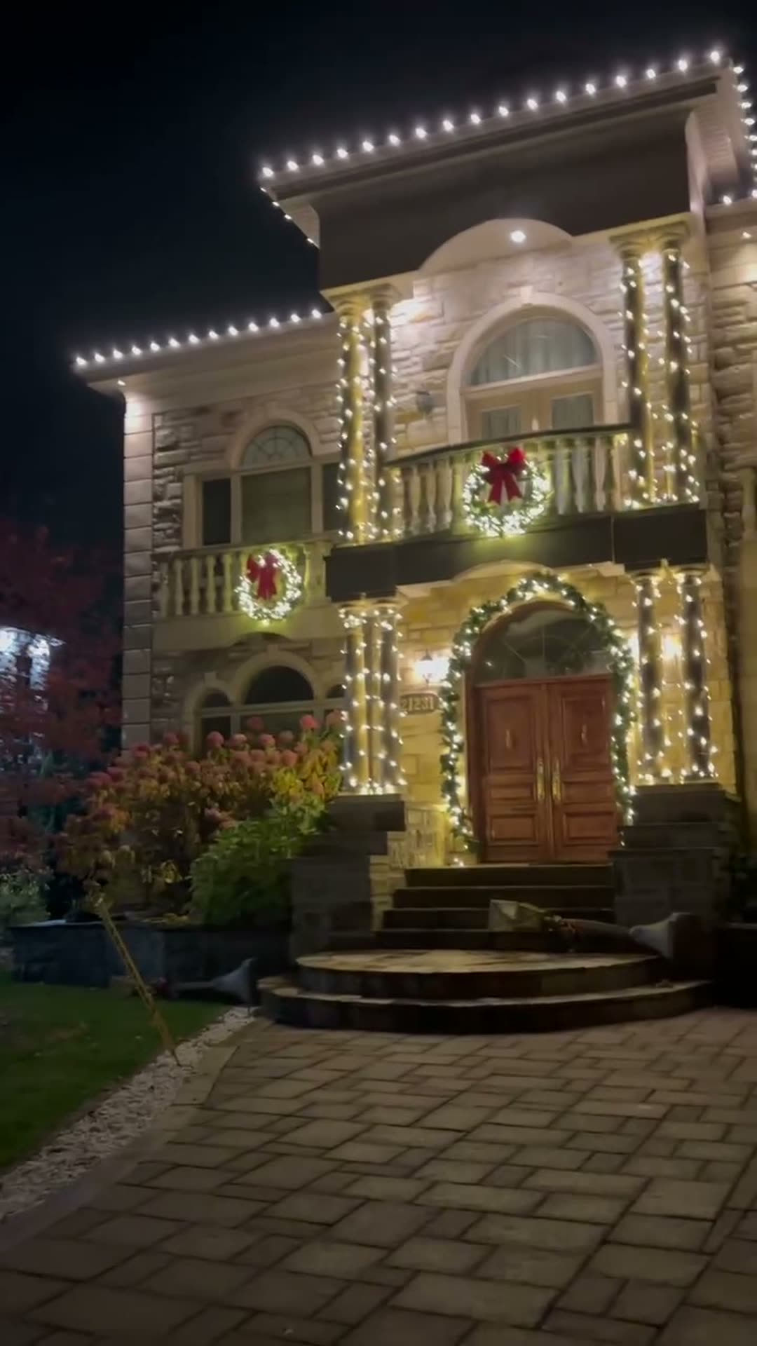 Stone estate lit with warm white Christmas lights